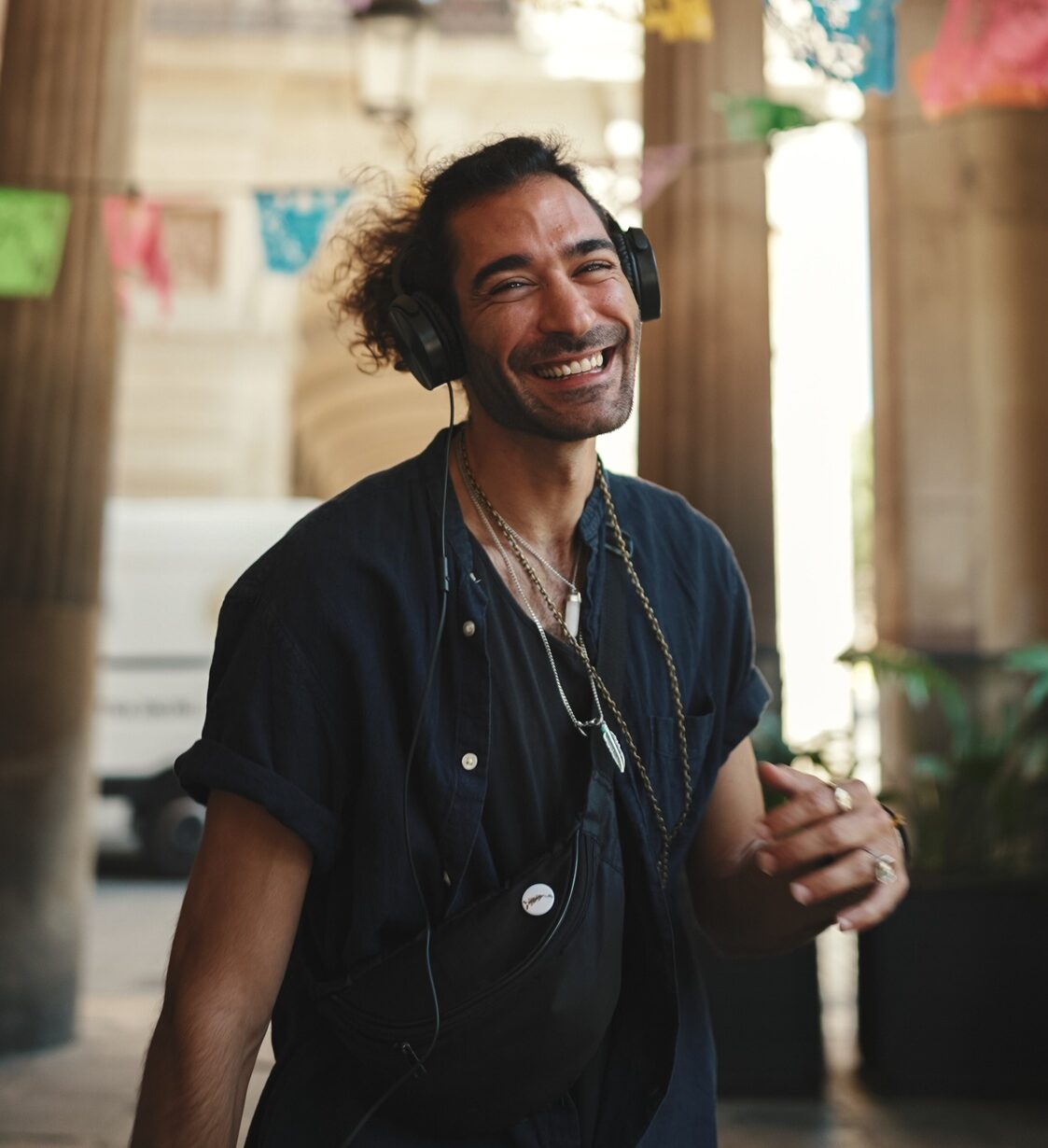Stylish guy listens to music in headphones
